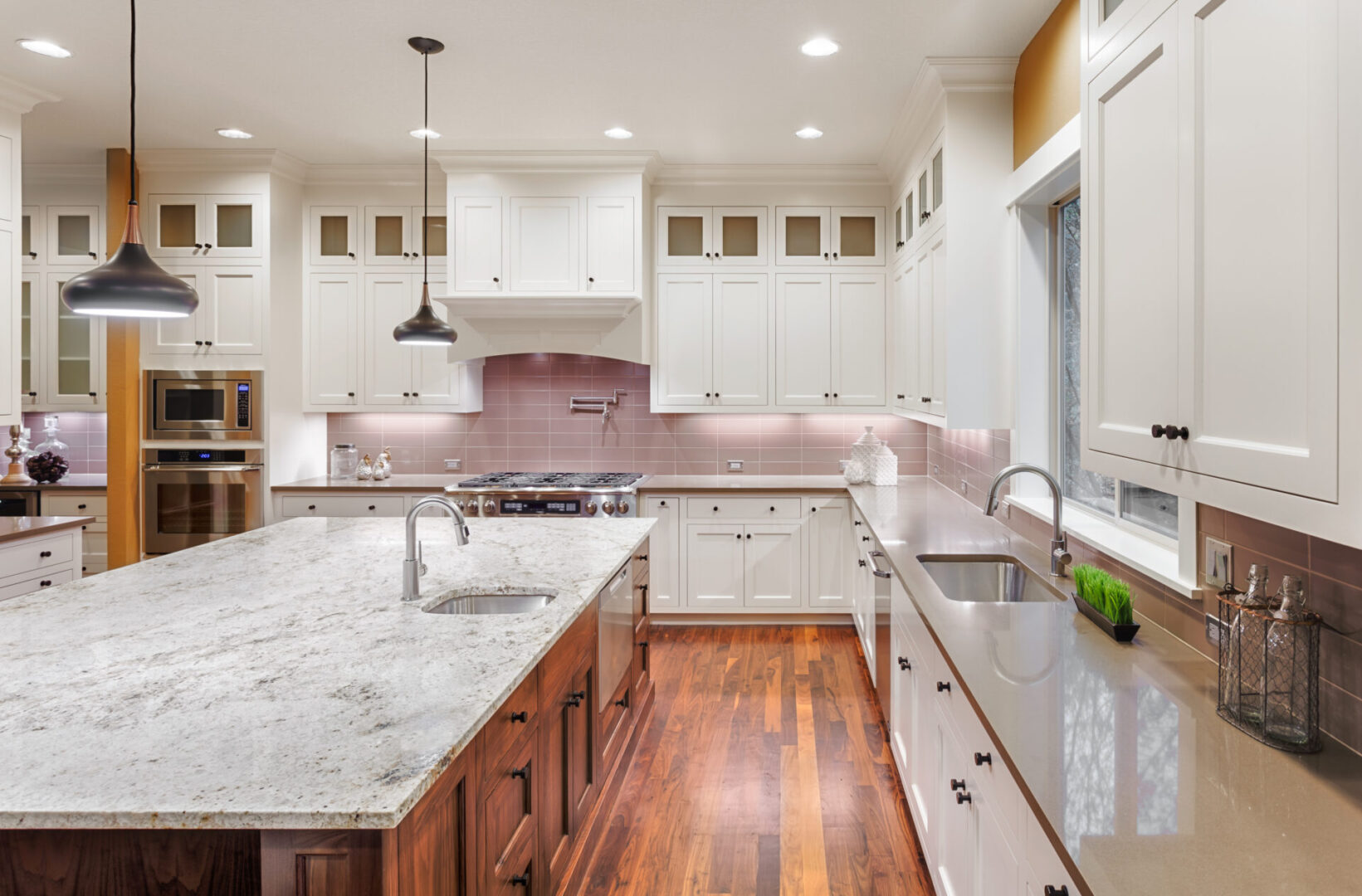 Modern kitchen with white cabinets and island.